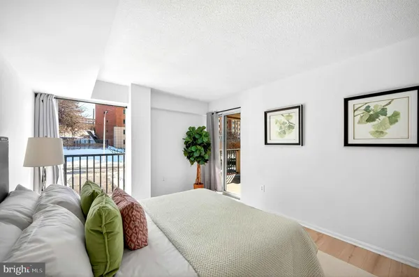 a bedroom with a bed and a painting on the wall