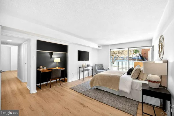 a bedroom with a bed and a couch