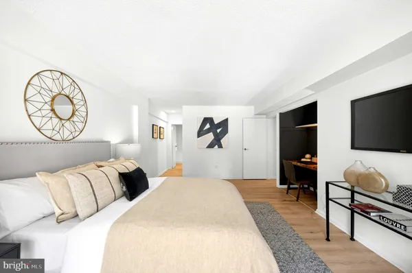 a bedroom with furniture and a flat screen tv