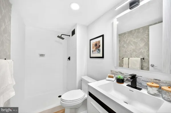 a bathroom with a sink toilet and vanity