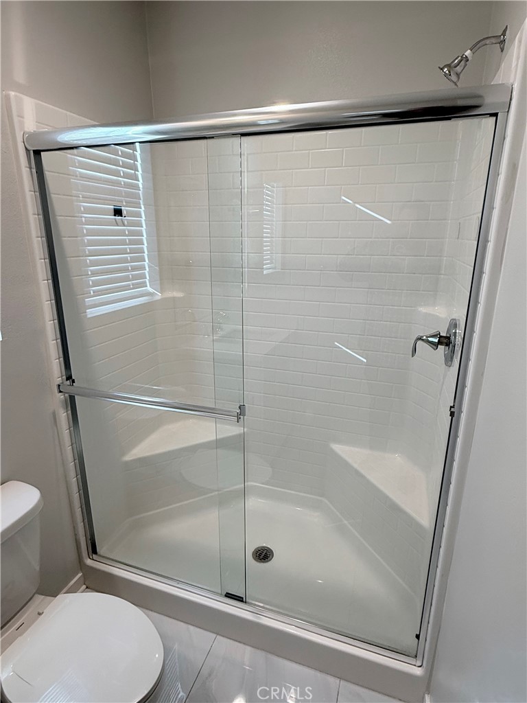 31124 Hanover Lane Menifee, CA 92584 - Photo 11 of 58 a bathroom with a shower and a toilet