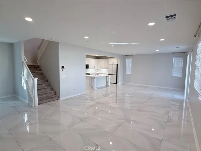 a kitchen with stainless steel appliances granite countertop a refrigerator and a stove top oven