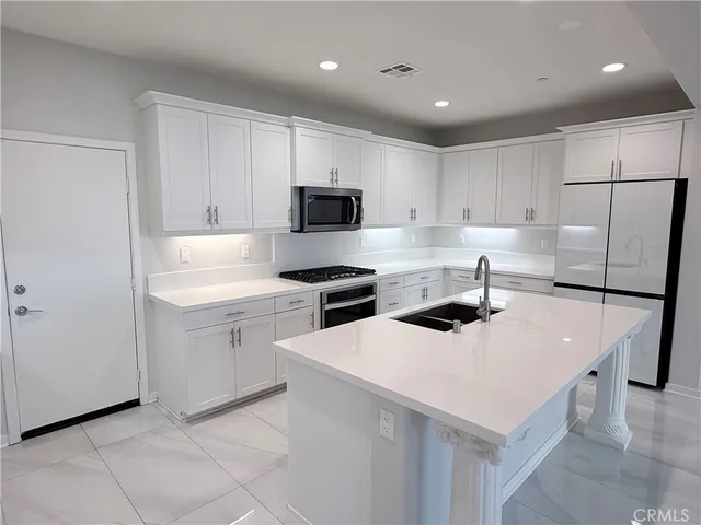 a stove top oven sitting inside of a kitchen