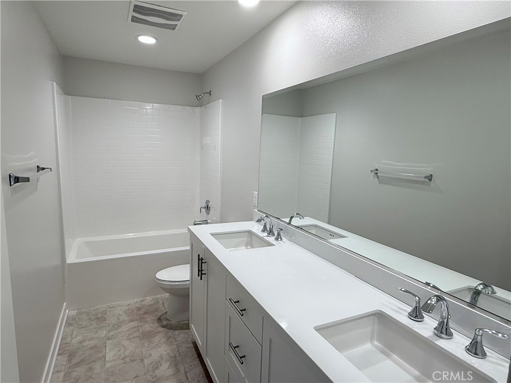 31124 Hanover Lane Menifee, CA 92584 - Photo 44 of 58 a bathroom with a sink double vanity granite toilet tub and shower