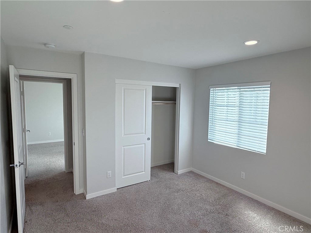 31124 Hanover Lane Menifee, CA 92584 - Photo 46 of 58 a view of an empty room with closet and a window
