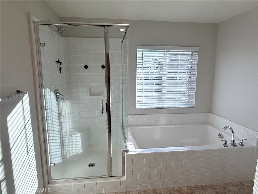 31124 Hanover Lane Menifee, CA 92584 - Photo 54 of 58 a bathroom with a bathtub and a shower