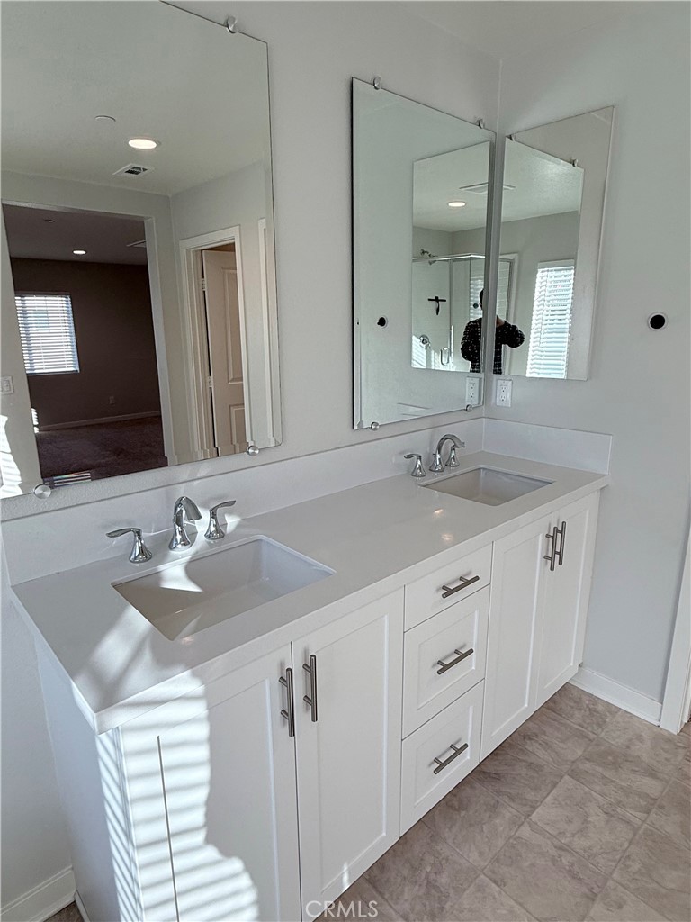 31124 Hanover Lane Menifee, CA 92584 - Photo 55 of 58 a bathroom with a sink double vanity and a mirror
