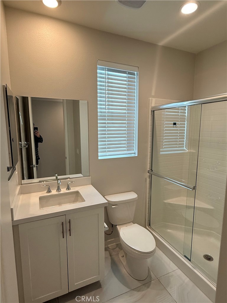 31124 Hanover Lane Menifee, CA 92584 - Photo 10 of 58 a bathroom with a toilet sink and a mirror