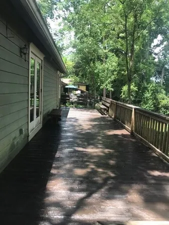 a view of backyard of house with wooden floor
