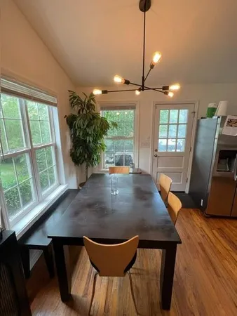 a bedroom with a bed and a dresser next to a window