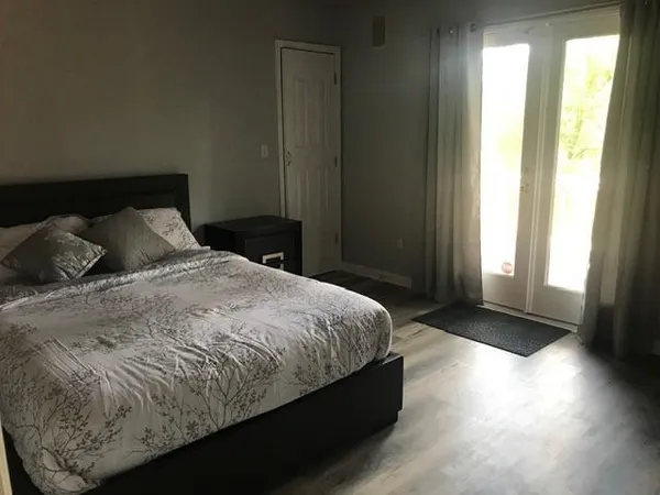a bedroom with a bed and a window