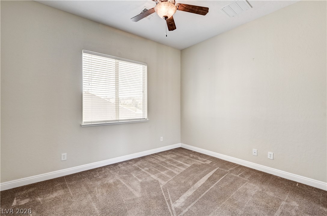 2793 Rosenhearty Drive Henderson, NV 89044 - Photo 50 of 85 A well-proportioned bedroom features soft carpeting and a window offering natural illumination.