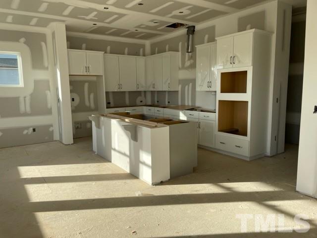 4429 Bridle Run Drive Raleigh, NC 27606 - Photo 8 of 14 a kitchen with stainless steel appliances granite countertop a stove a refrigerator and a white cabinets