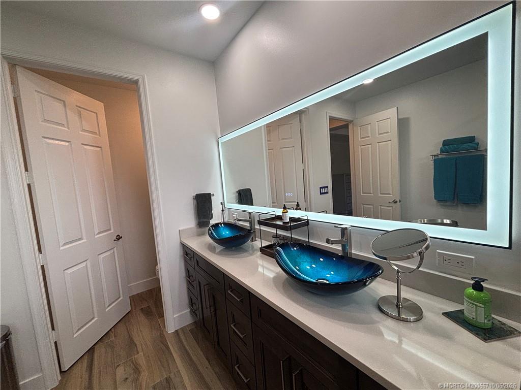 262 Southwest Walking Path, Unit 262 Stuart, FL 34997 - Photo 31 of 39 a bathroom with a granite countertop sink and a mirror