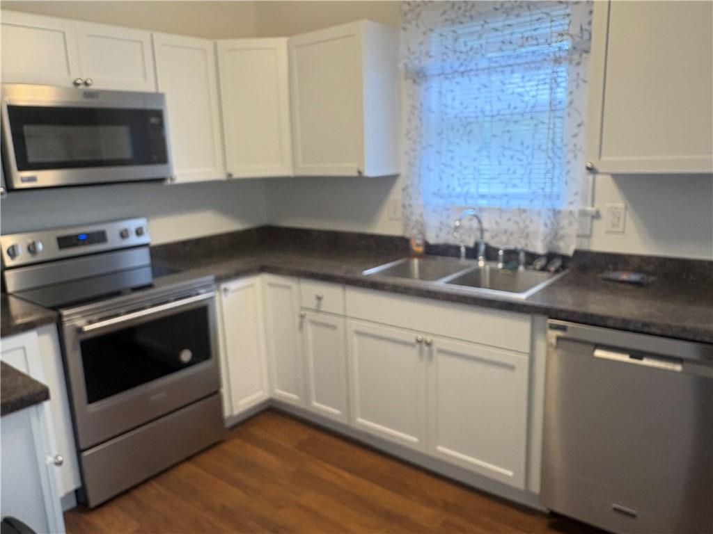 3821-3841 Evergreen Road New Bedford, PA 16143 - Photo 9 of 31 a kitchen with appliances a sink and cabinets