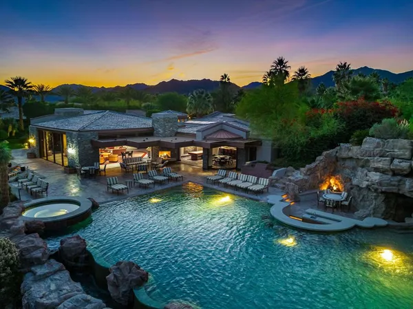 a front view of a house with yard and outdoor seating