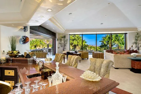 a kitchen with stainless steel appliances kitchen island granite countertop a refrigerator stove and sink