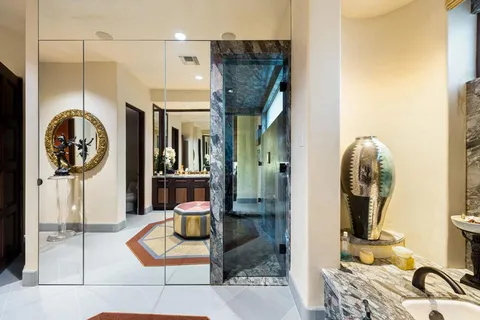 a front view of a house with a yard and trees