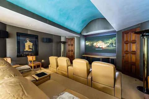 a view of a house with swimming pool and sitting area