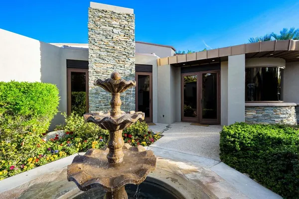 a view of a swimming pool with a yard and plants
