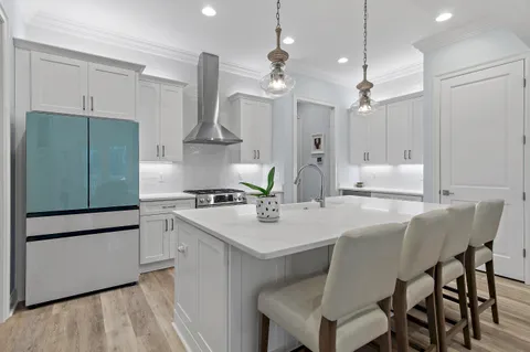 a kitchen with a stove a sink and a refrigerator