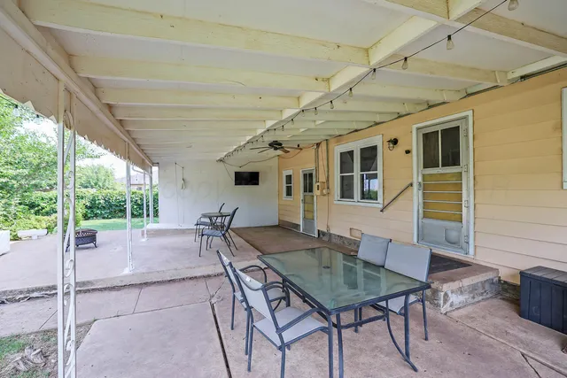 a view of a patio with table and chairs