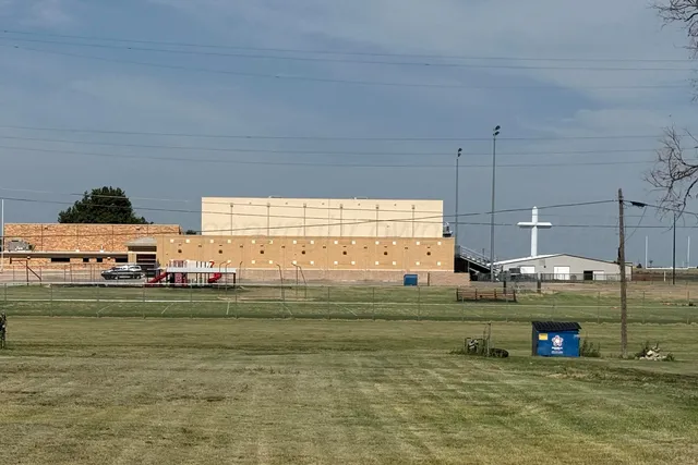 a view of a kitchen with stainless steel appliances granite countertop a barbecue grill and a view of the ocean view