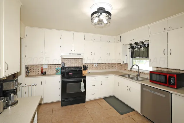 a kitchen with a stove and a sink