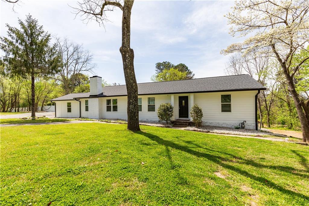 1940 Farmer Road Northwest Conyers, GA 30012 - Photo 1 of 1 a front view of a house with a garden and patio