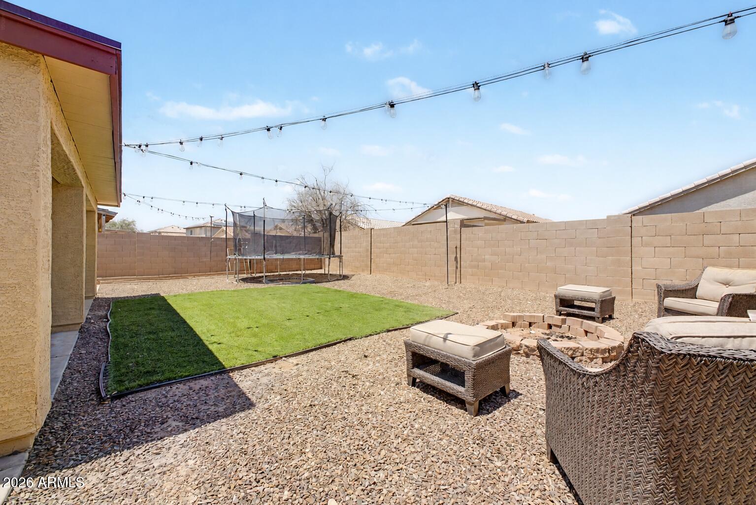 12008 West Larkspur Road El Mirage, AZ 85335 - Photo 19 of 25 a patio with table and chairs
