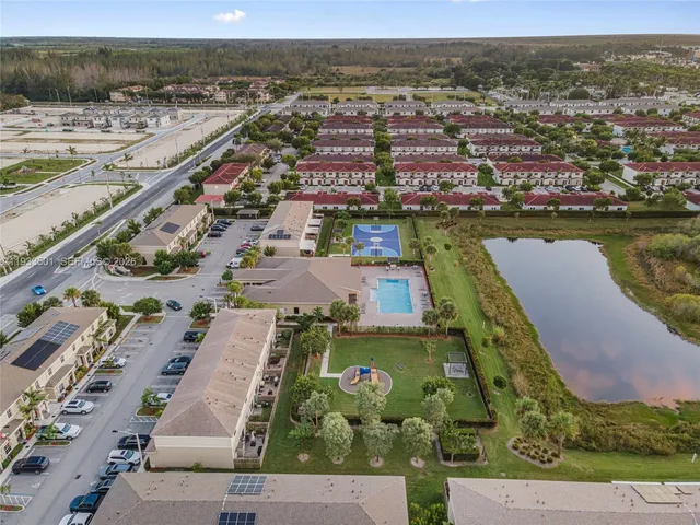 an aerial view of residential building and lake