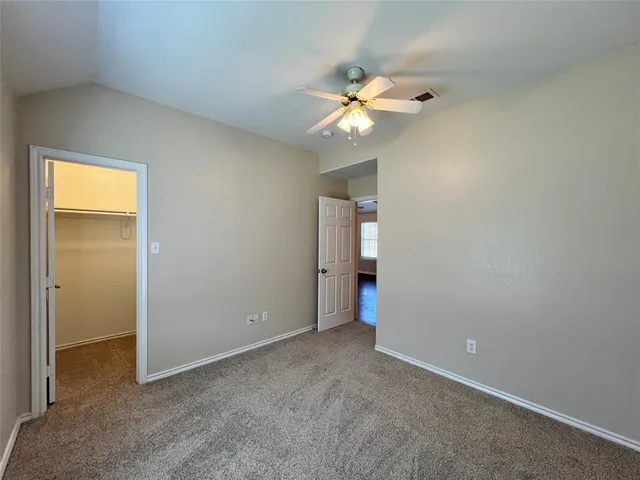 a view of an empty room with a fan