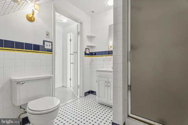 a bathroom with a toilet and a shower