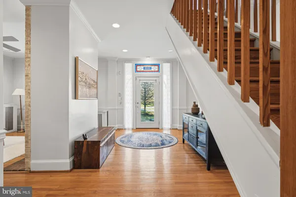 a view of a livingroom with wooden floor and stairs