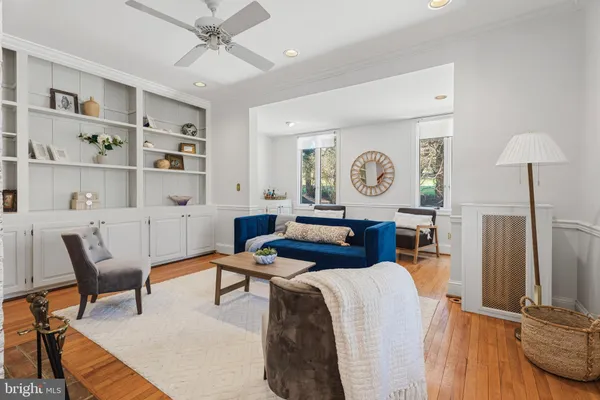 a living room with furniture and a clock