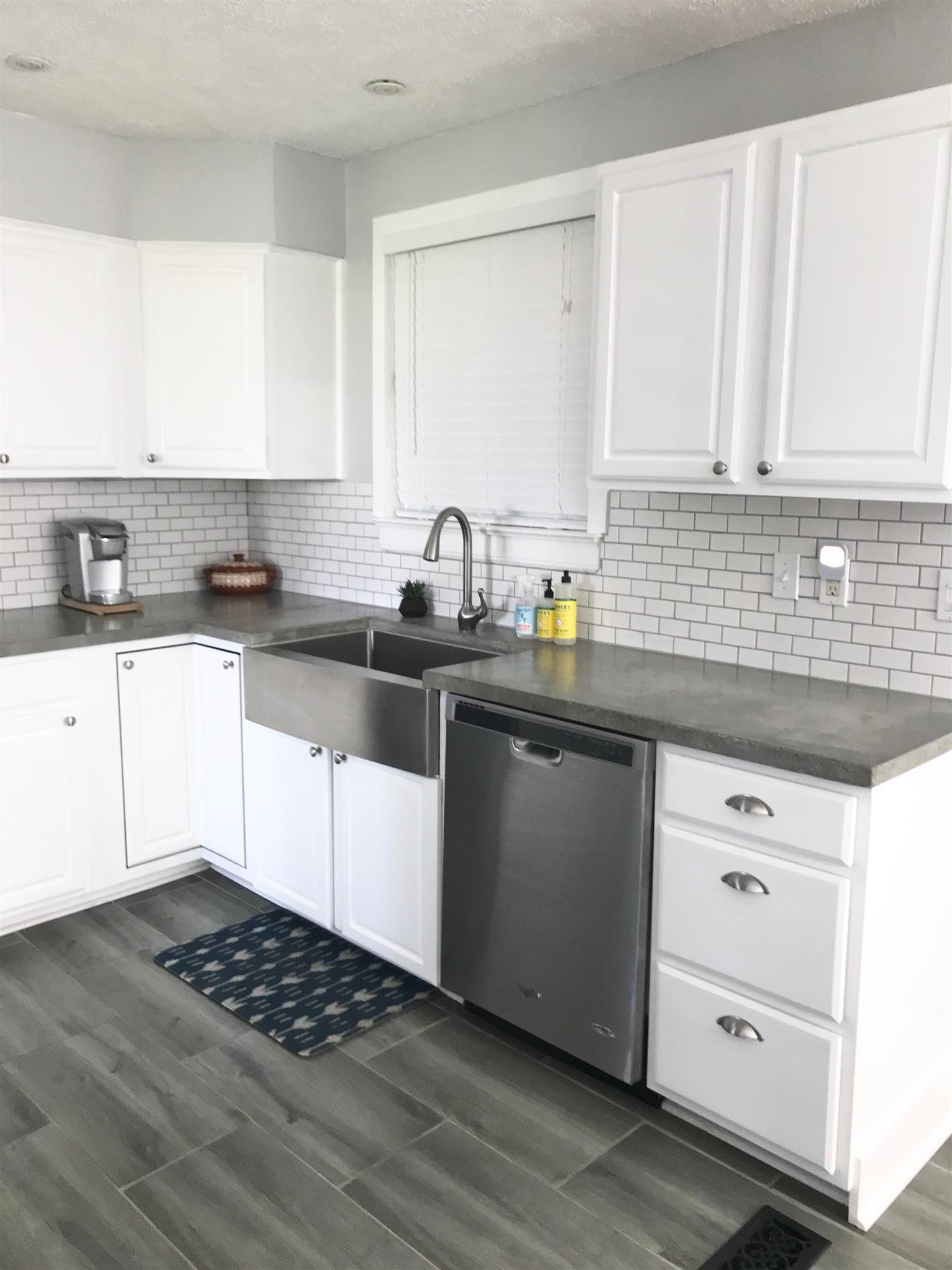 1950 Porter Road Nashville, TN 37206 - Photo 5 of 30 Subway Tile Backsplash, Nicely Tiled Floor and Concrete Counters
