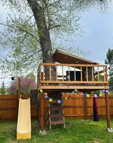 a front view of a house with plants