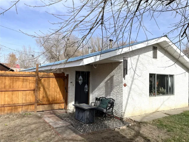 a view of a patio with table and chairs with wooden floor and fence