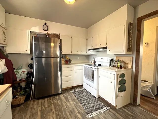 a bedroom with a bed a table and chair