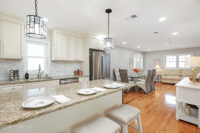 a kitchen with a sink stove top oven and cabinets