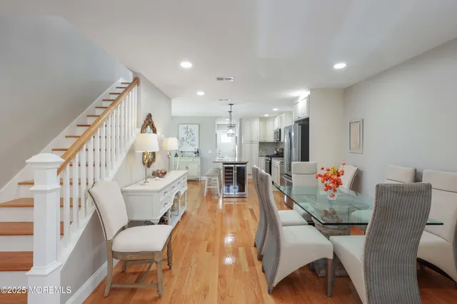 a living room with furniture a wooden floor and a large window