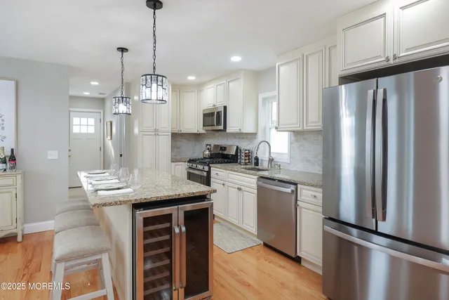 a living room with furniture and a dining table with kitchen view