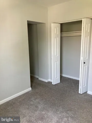 an empty room with closet area