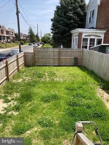 a view of a backyard with a garden and deck