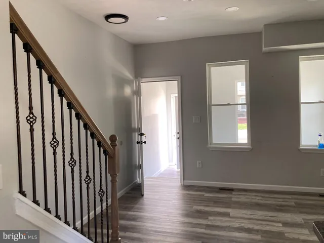 a view of an entryway with wooden floor and stairs
