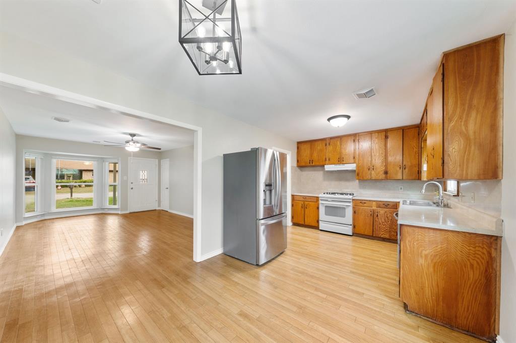 753 Cullum Avenue Hurst, TX 76053 - Photo 11 of 26 a view of a kitchen with a sink stainless steel appliances cabinets and a large window