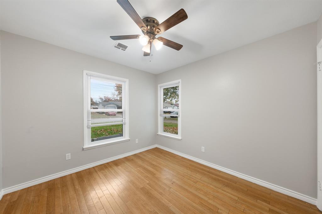 753 Cullum Avenue Hurst, TX 76053 - Photo 21 of 26 an empty room with wooden floor and windows