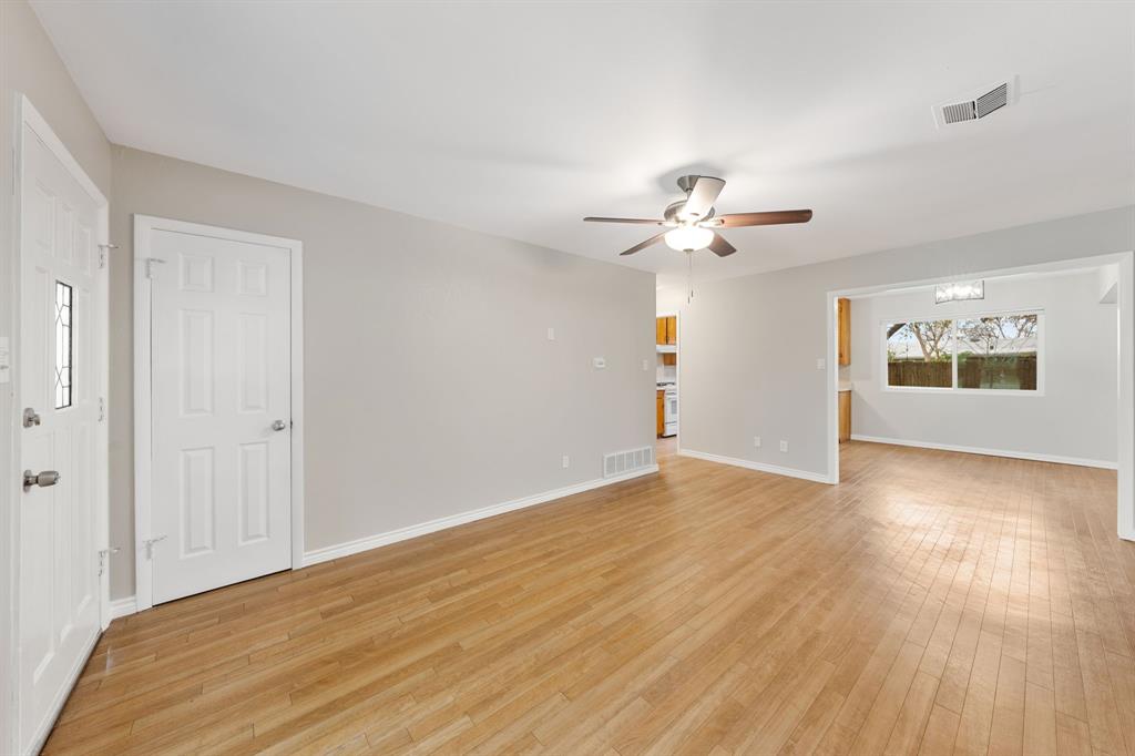 753 Cullum Avenue Hurst, TX 76053 - Photo 5 of 26 a view of an empty room with a window and a ceiling fan