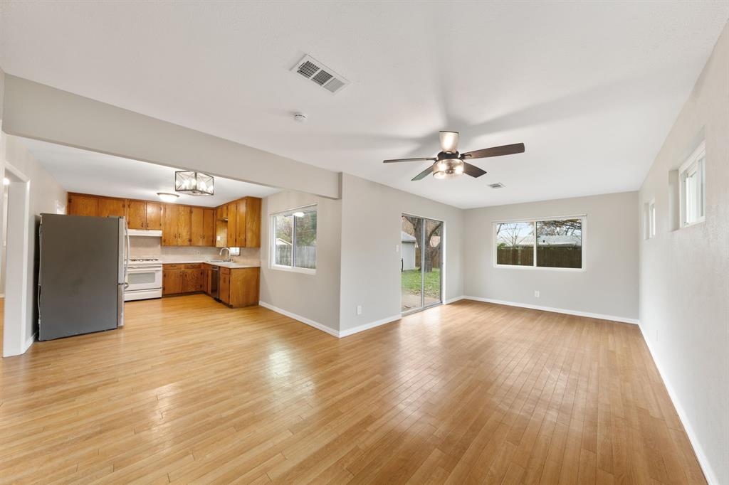 753 Cullum Avenue Hurst, TX 76053 - Photo 8 of 26 a view of an empty room with window and wooden floor