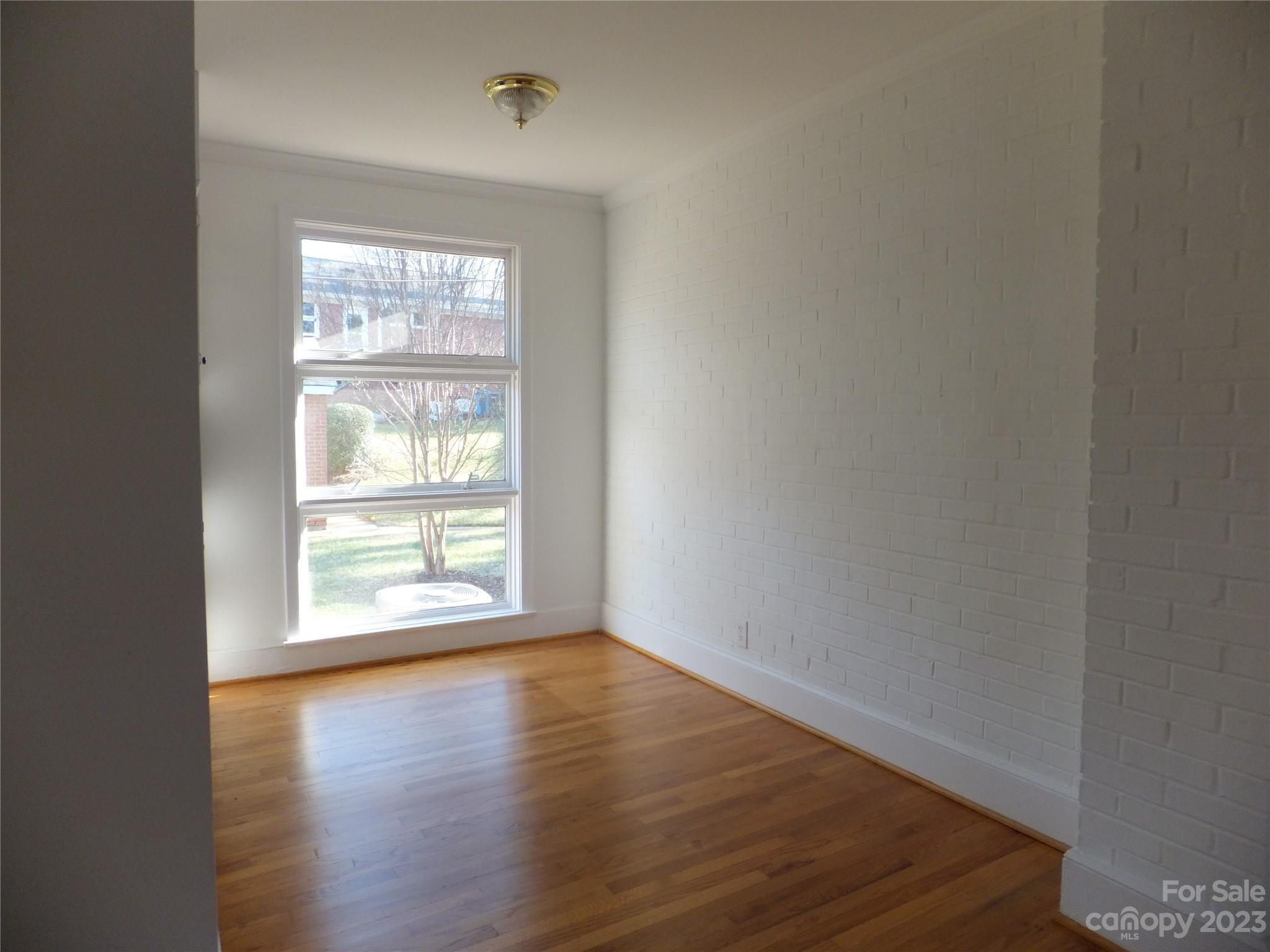 4222 Randolph Road Charlotte, NC 28211 - Photo 4 of 18 an empty room with wooden floor and windows